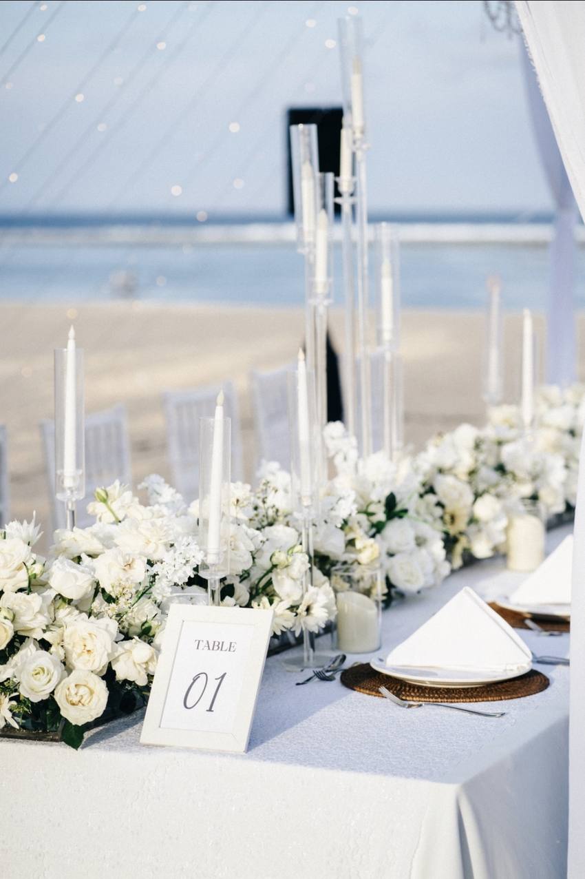 White roses and candles on the engagement dinner table